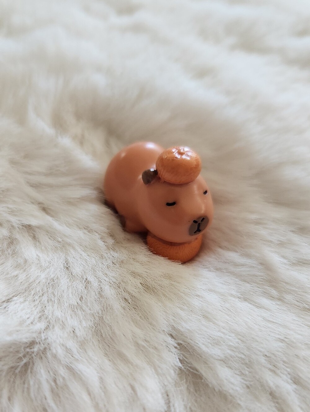 Capybara and orange figure